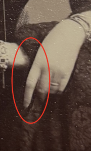 Close up on a Victorian photograph, showing evidence of retouching in the hands.